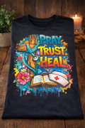 Pray. Trust. Heal. – Faith-Based Nurse Graphic Tee